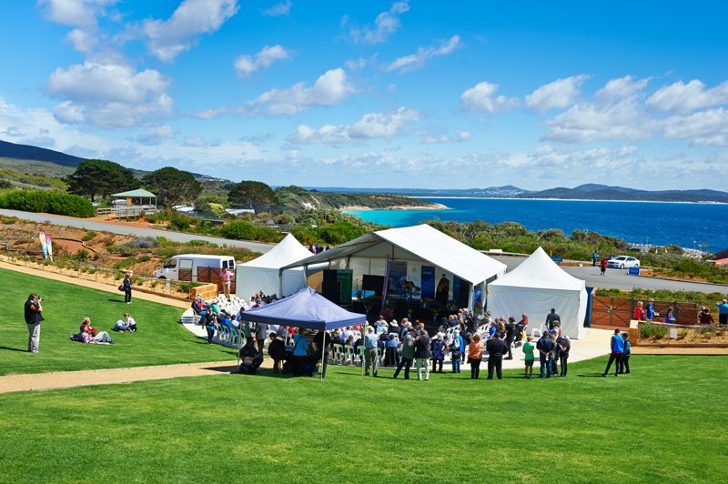 Grassed amphitheatre with marquee and crowd