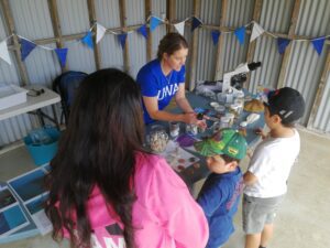 Dr Kate Sprogis with family enjoying marine science activity.